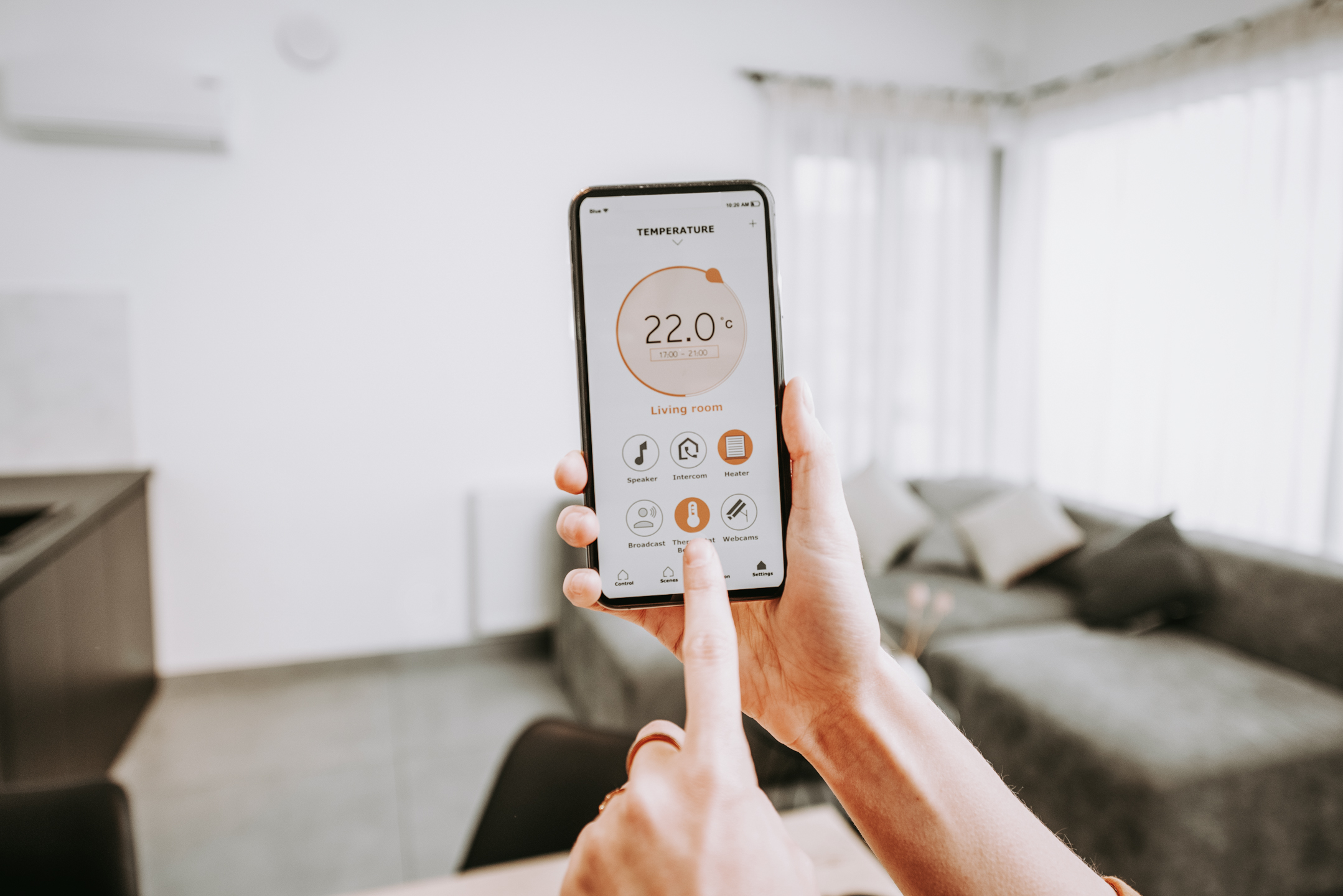 Controlling home heating temperature with a smart home, close-up on phone. Concept of a smart home and mobile application for managing smart devices at home